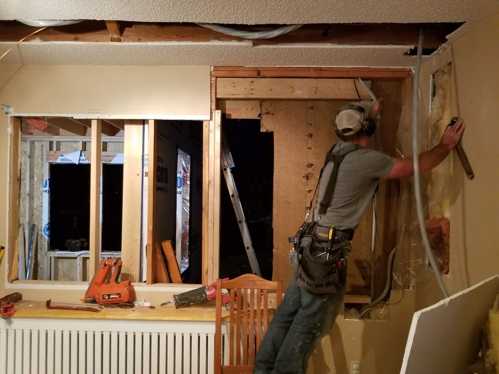 Cutting the old window out of the wall that was about to become interior, November 2018