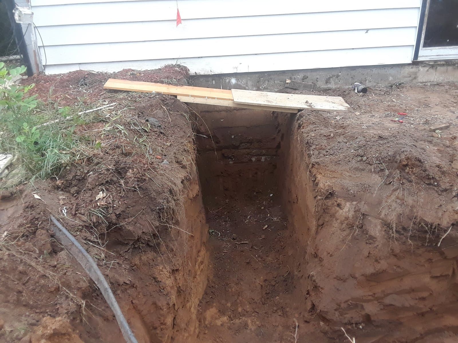 Mini excavator digging the footings, July 1, 2018