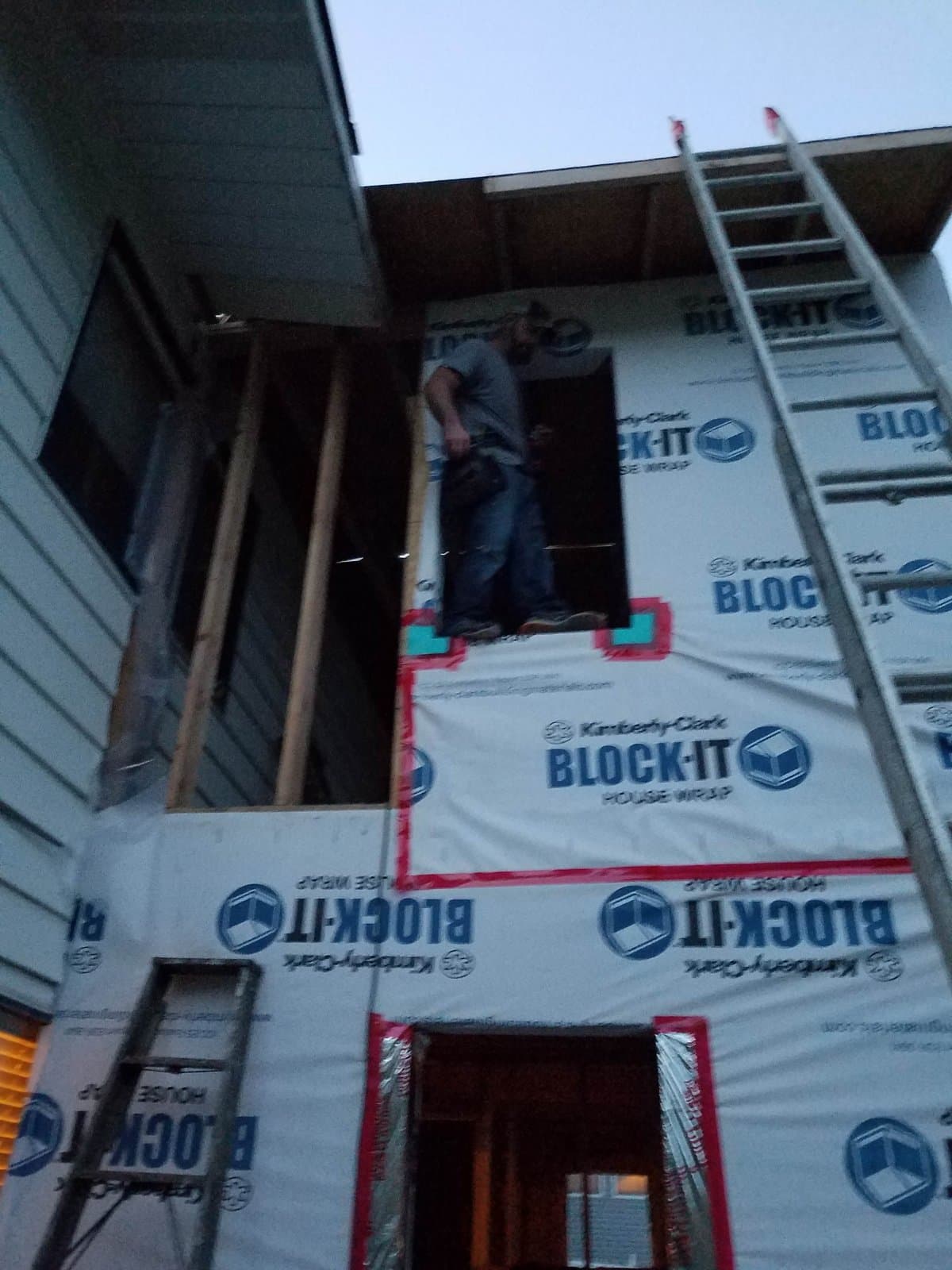 Me in the corner gap at dusk, wrap on, the opening the trusses came through still open