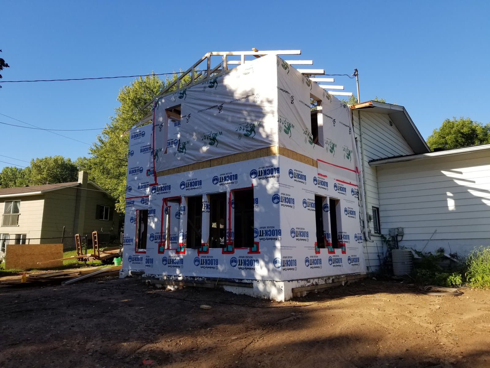 The addition wrapped, from the yard