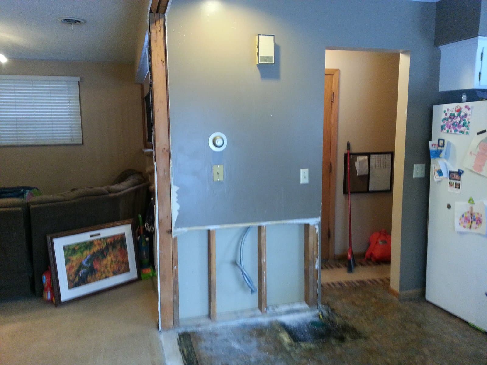 The kitchen wall half-opened, studs exposed, October 2017
