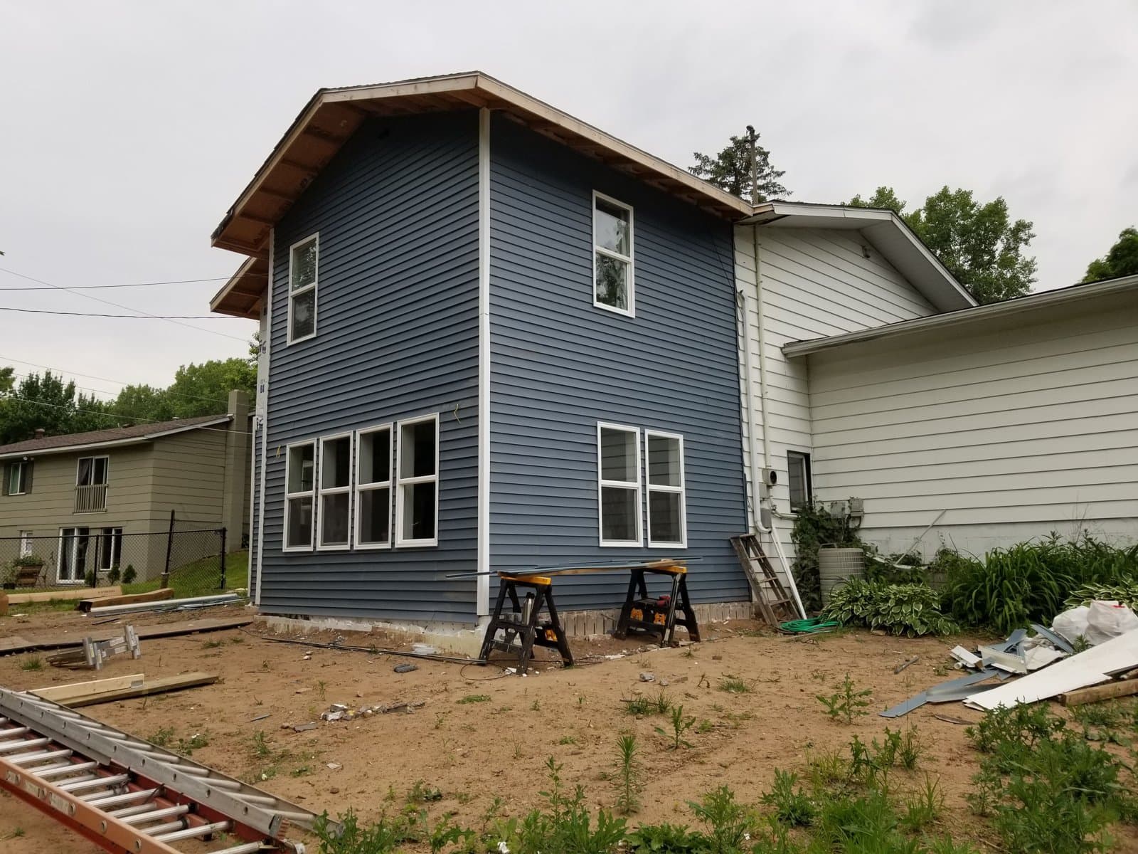 Blue lap siding on the finished addition, June 2019