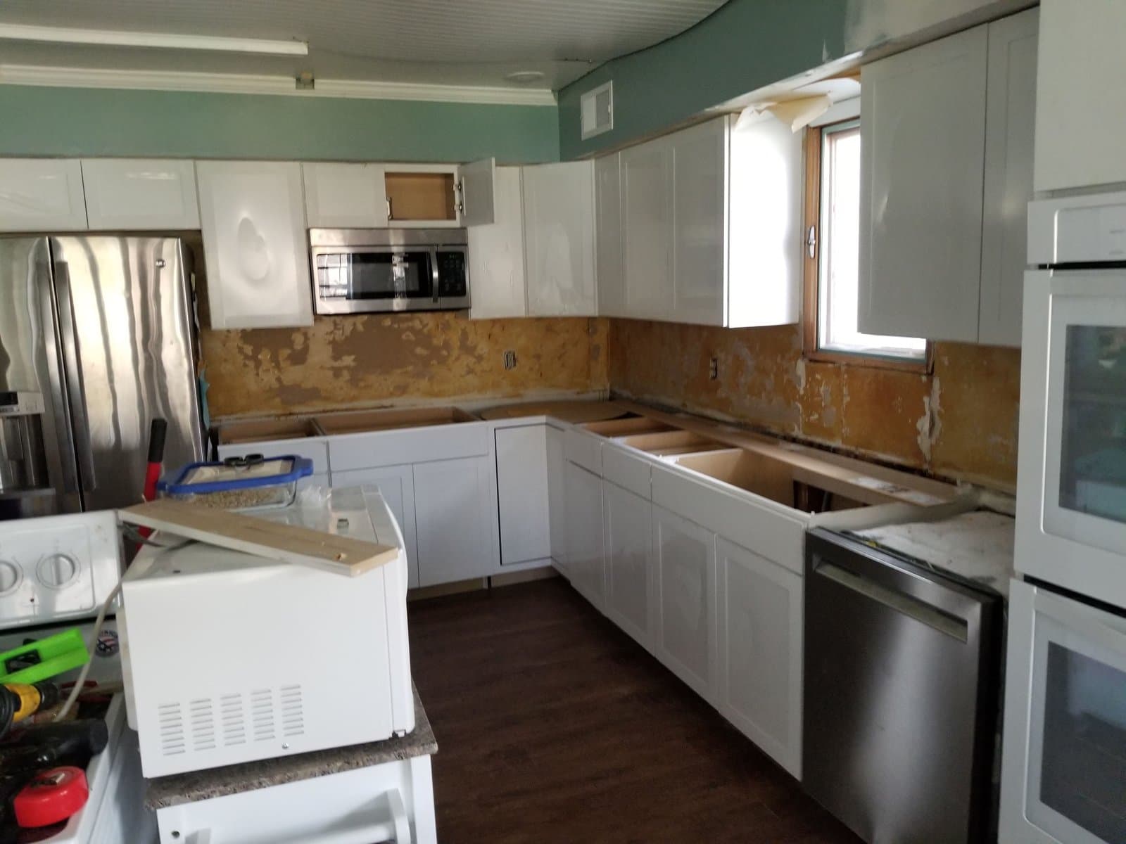 Counters out, new cabinets and the $400 double oven in, April 2021