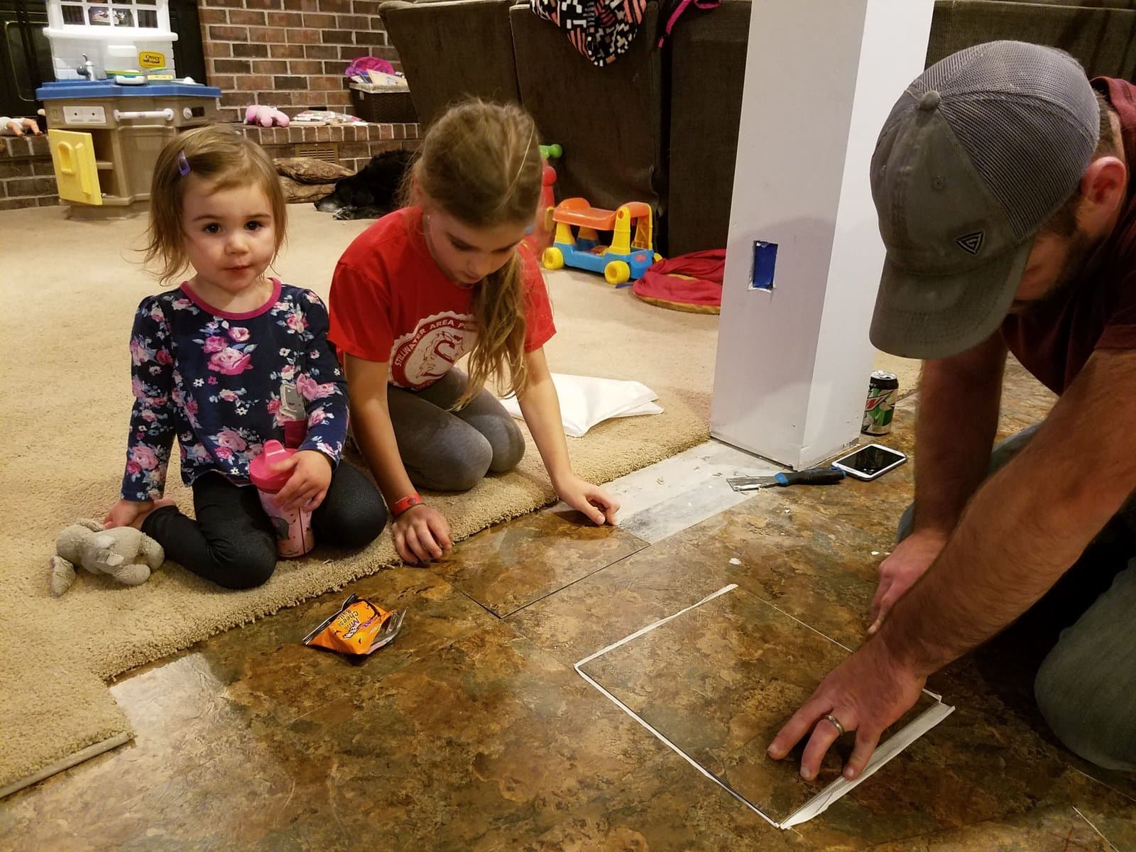 Laying the new tile floor with both girls helping, November 2017