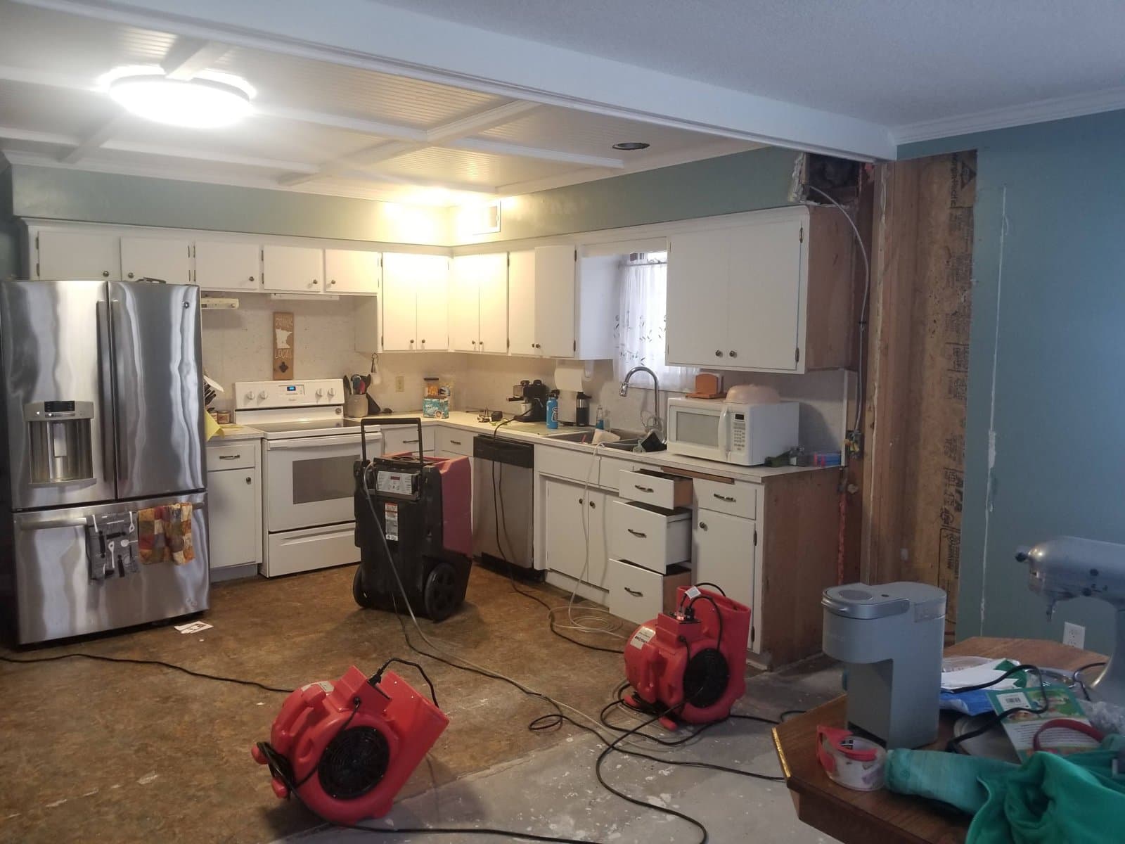 Air movers and dehumidifiers in the kitchen after the ice dams, January 2021