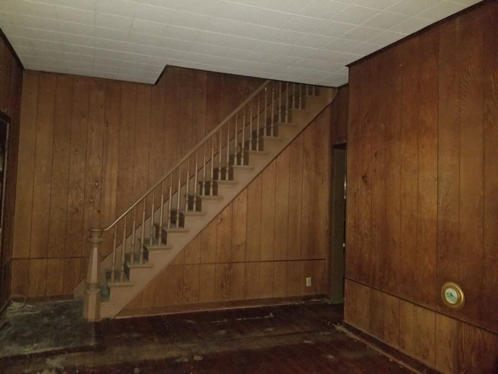 Wood paneling on every wall downstairs, stairs to the second floor