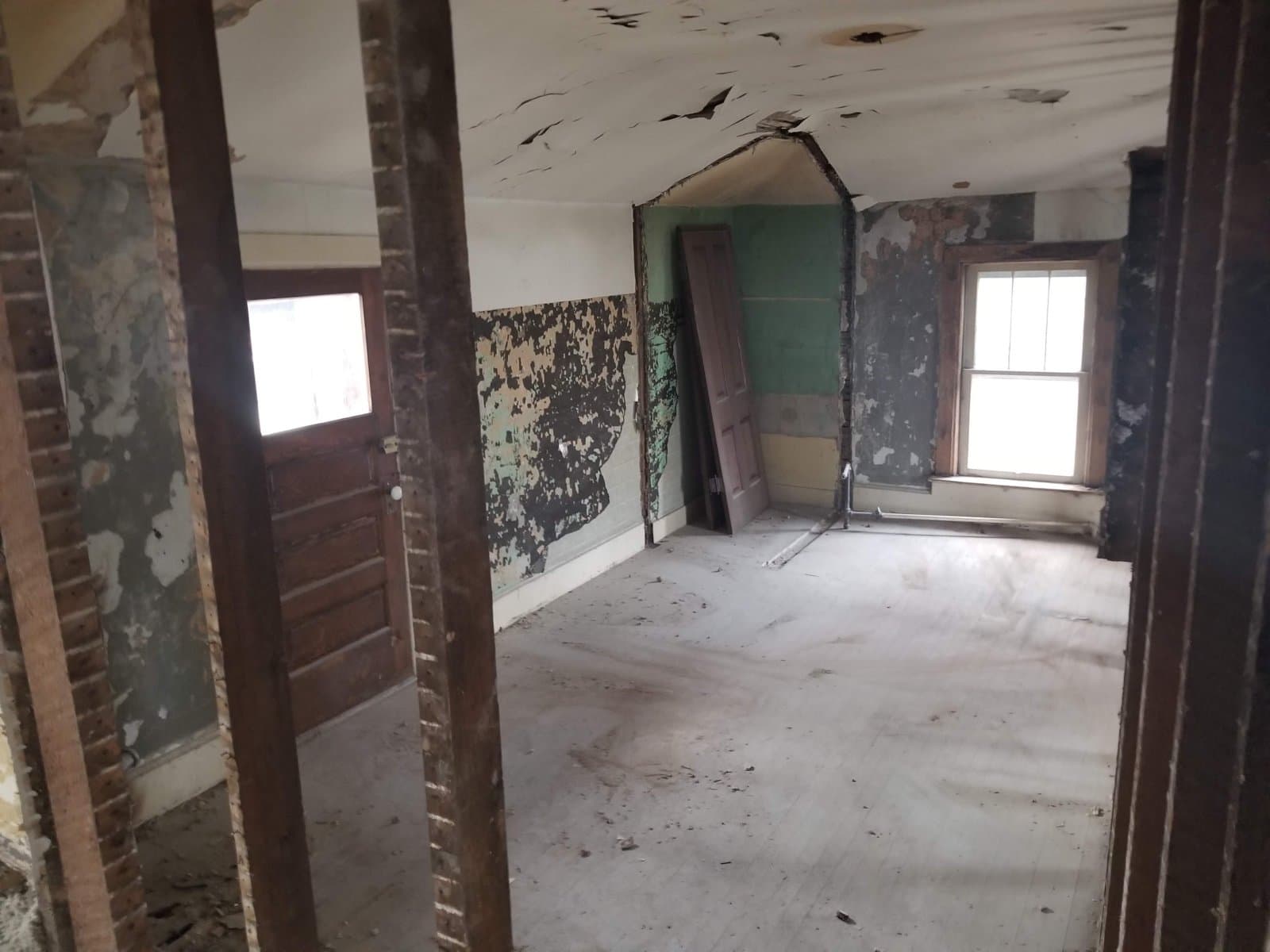 Upstairs, plaster off the walls