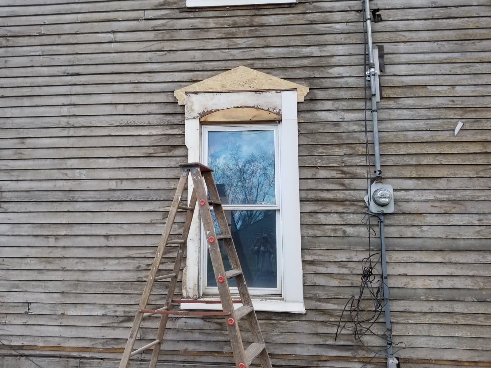 Tile siding off, original clapboard exposed, April 2020