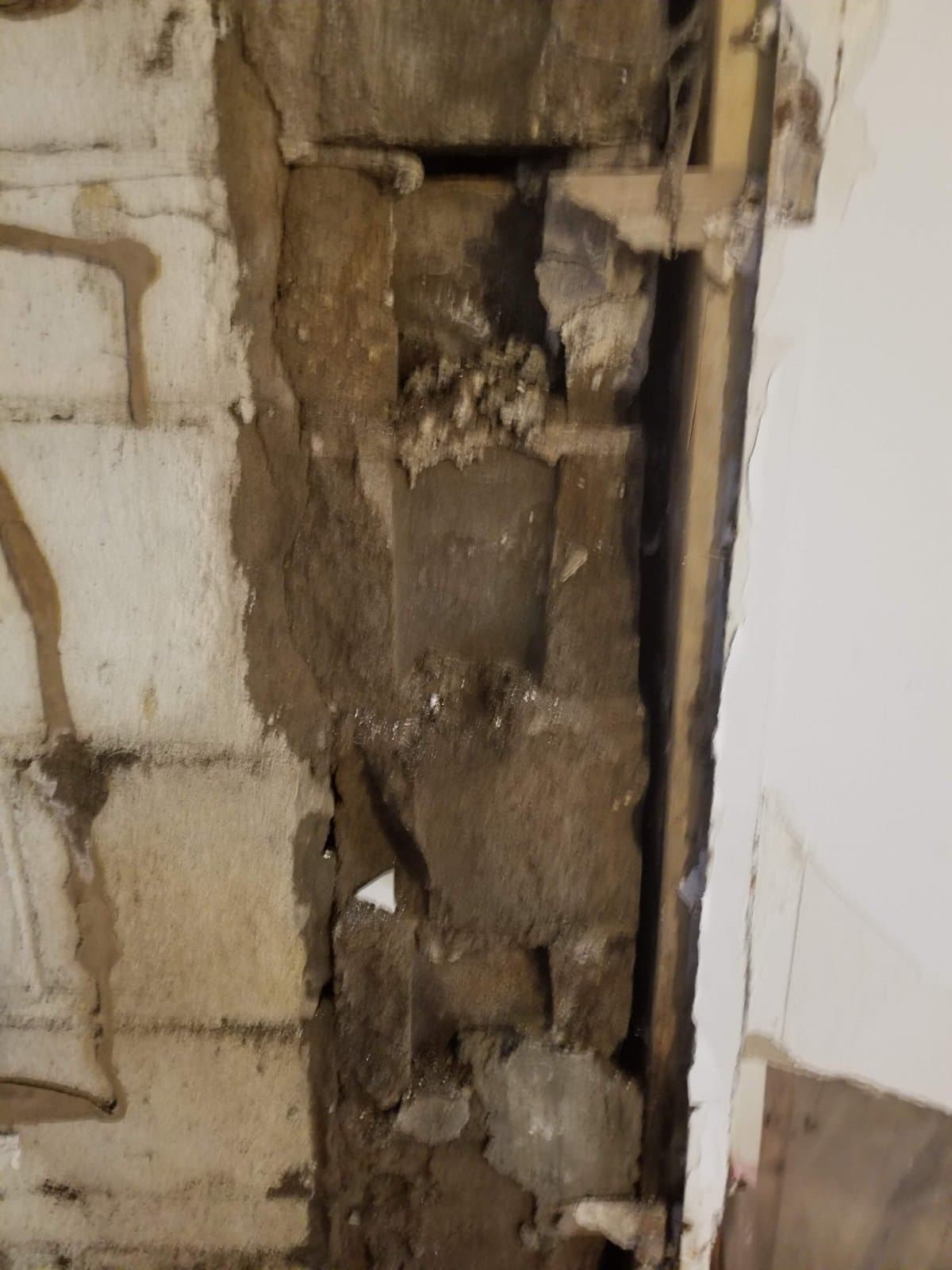 Block wall with mortar gone and the face crumbling