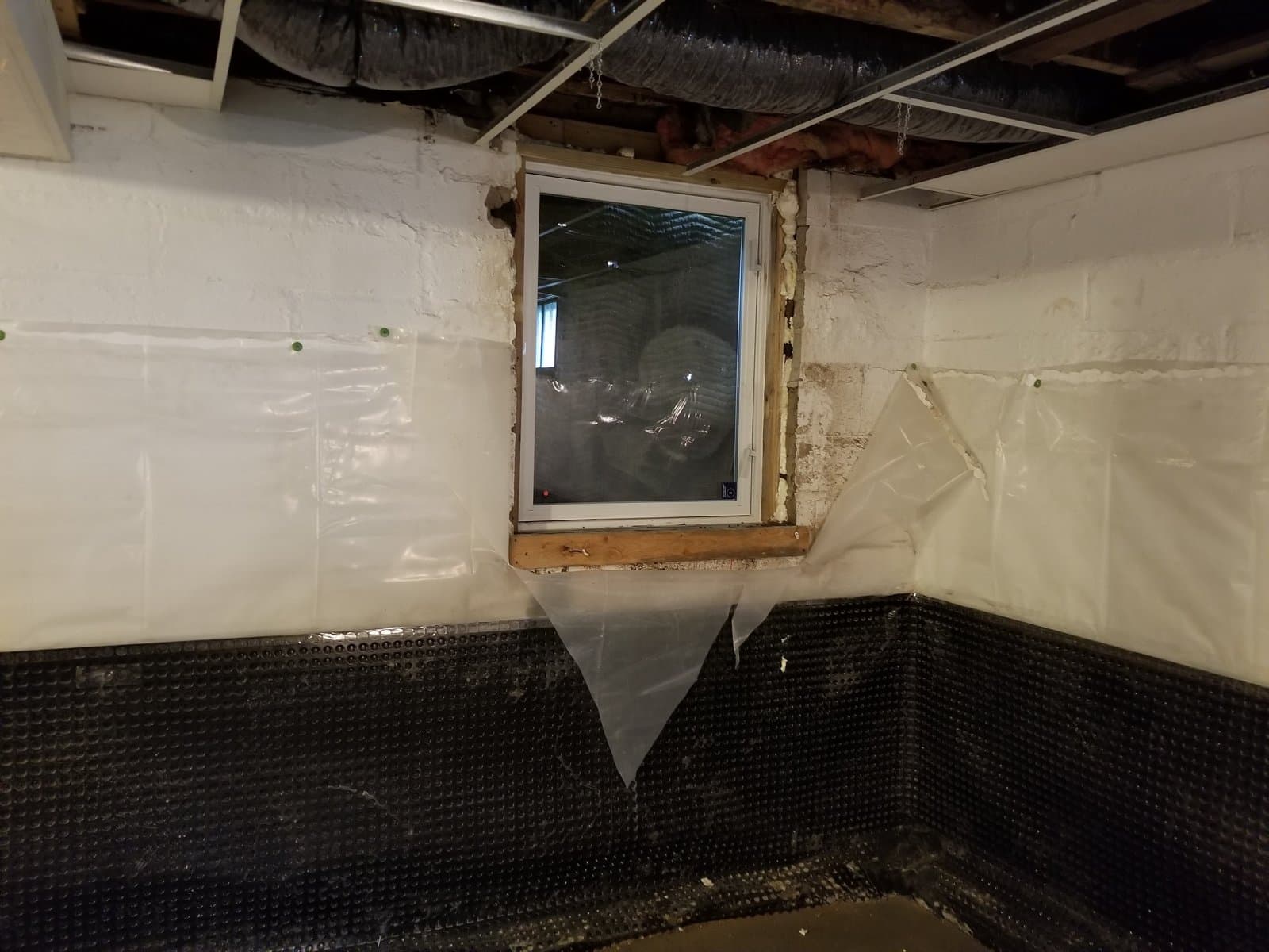The opening for the egress window in the new bedroom