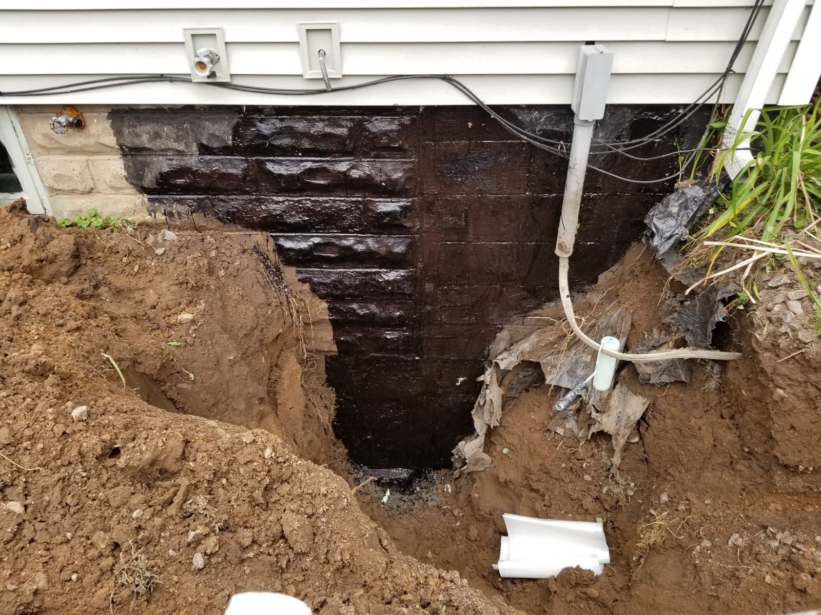 The exposed block wall below grade
