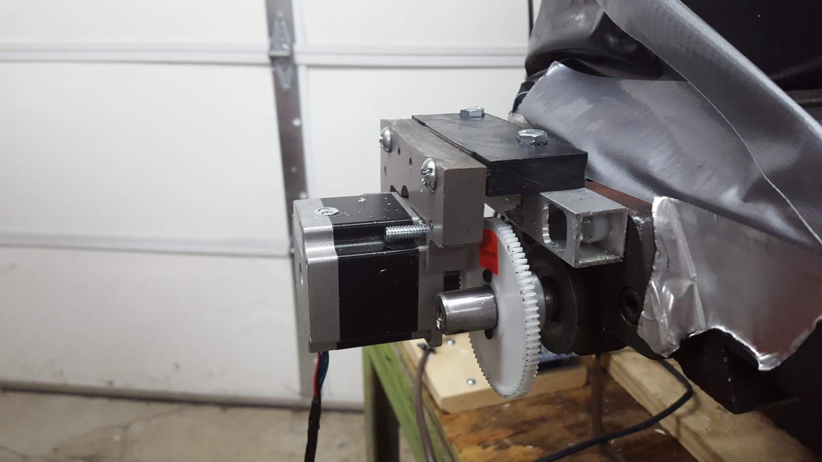 Stepper motor mounted to the X-axis with a gear coupling