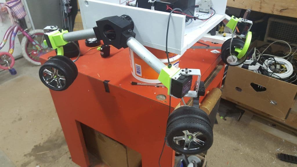 Rover chassis with six wheels on a red workbench