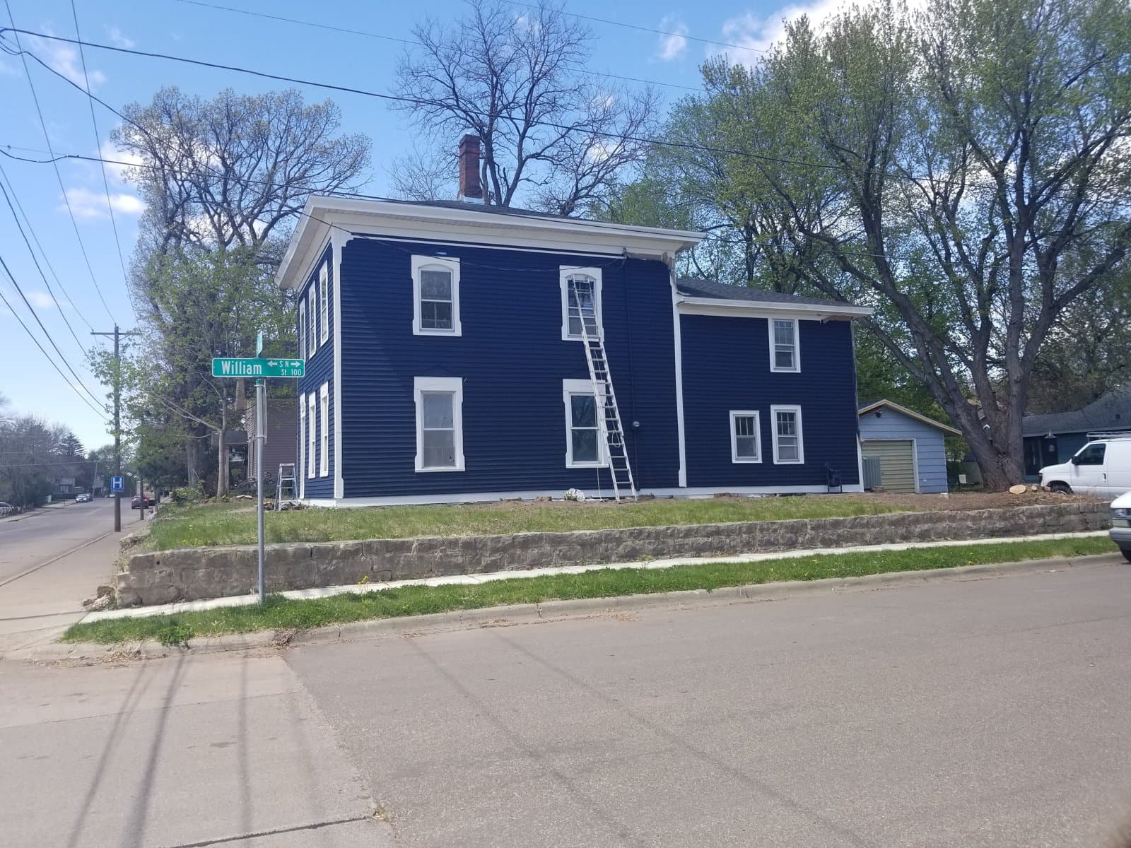 The Myrtle house from the corner, painted blue with white trim, May 2020